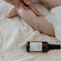 baby having massage with the baby oil